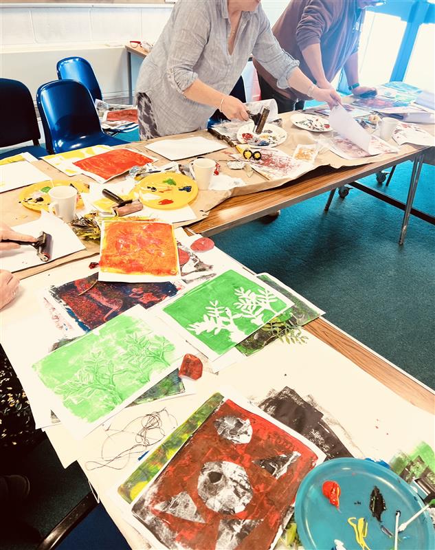 Photograph of participants creating artworks at an in person workshop
